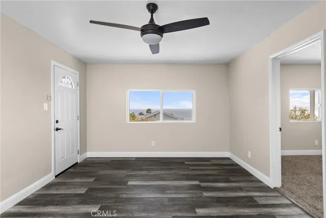 a view of room with hardwood floor and ceiling fan
