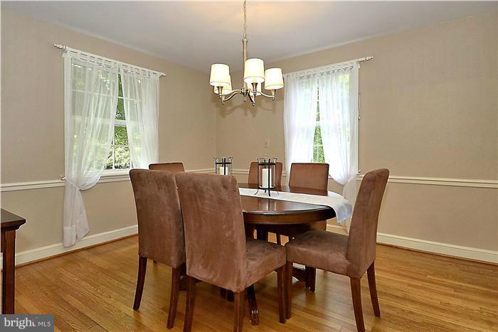 1912 Hanover Street Silver Spring, MD 20910 - Photo 1 of 29 a dining room with furniture a chandelier and wooden floor
