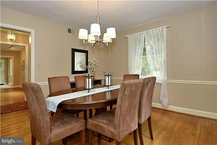 1912 Hanover Street Silver Spring, MD 20910 - Photo 4 of 29 a view of a dining room with furniture a chandelier and wooden floor