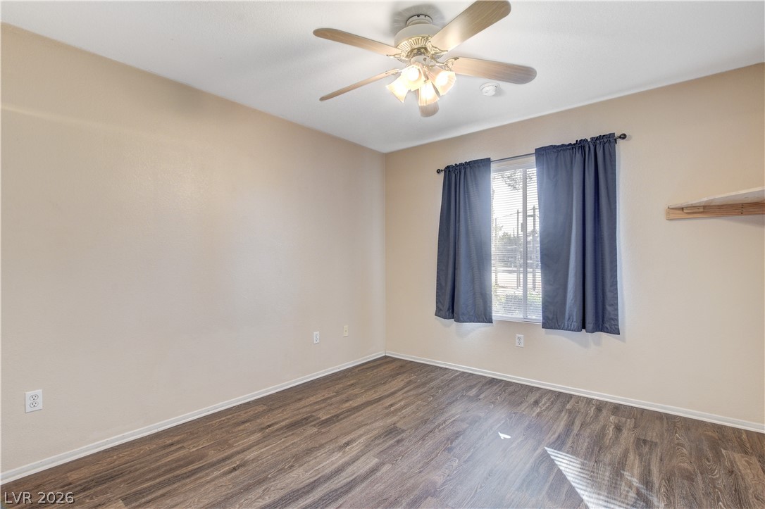 8070 West Russell Road, Unit 1064 Las Vegas, NV 89113 - Photo 16 of 35 Spare room featuring ceiling fan and dark wood-style floors