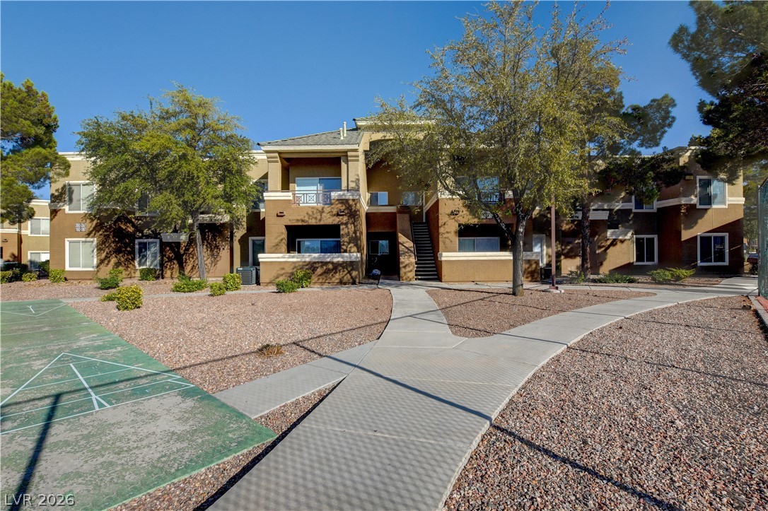8070 West Russell Road, Unit 1064 Las Vegas, NV 89113 - Photo 2 of 35 View of home's community featuring shuffleboard and a balcony
