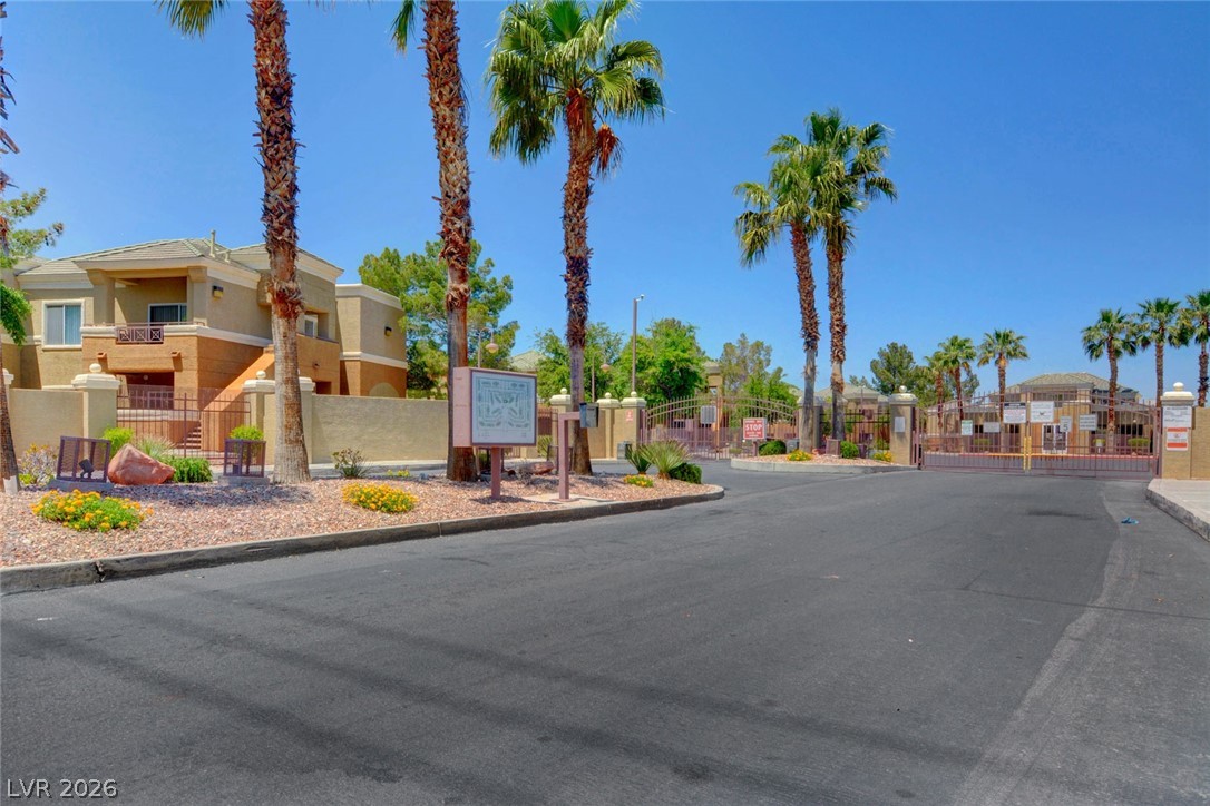8070 West Russell Road, Unit 1064 Las Vegas, NV 89113 - Photo 29 of 35 View of asphalt street featuring a gate, curbs, and a gated entry
