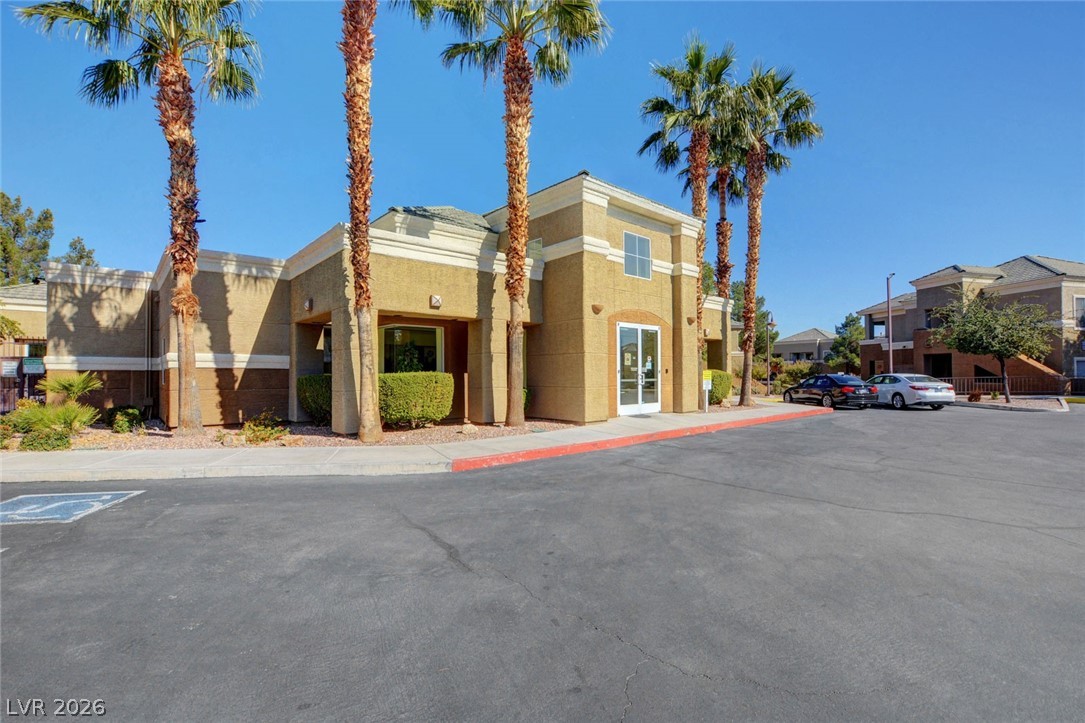 8070 West Russell Road, Unit 1064 Las Vegas, NV 89113 - Photo 30 of 35 View of building exterior featuring uncovered parking