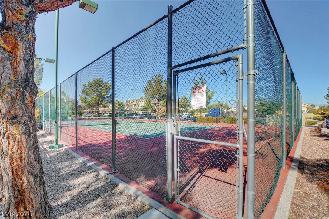 8070 West Russell Road, Unit 1064 Las Vegas, NV 89113 - Photo 31 of 35 View of tennis court with a gate