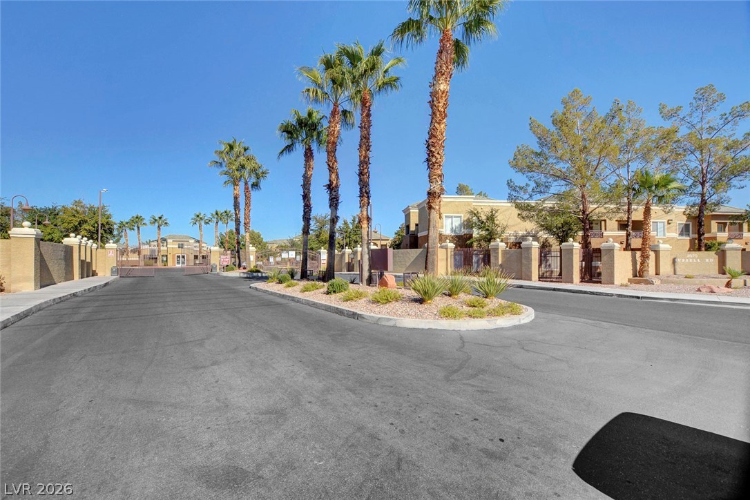 8070 West Russell Road, Unit 1064 Las Vegas, NV 89113 - Photo 35 of 35 View of asphalt street with sidewalks, curbs, a residential view, a gate, and a gated entry