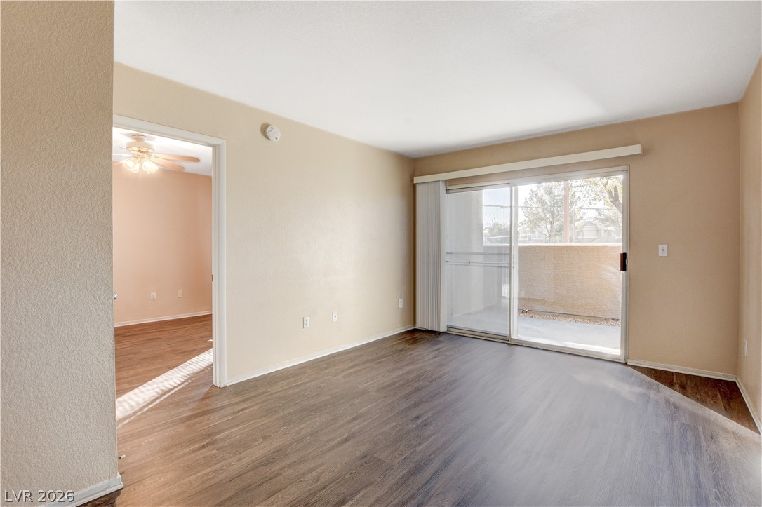 8070 West Russell Road, Unit 1064 Las Vegas, NV 89113 - Photo 5 of 35 Unfurnished room featuring wood finished floors and a ceiling fan