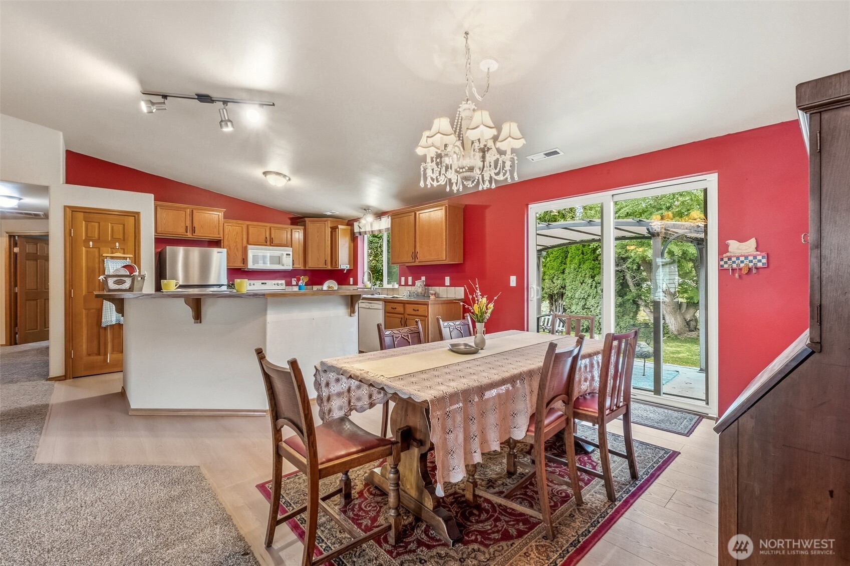 5197 Regan Road Cashmere, WA 98815 - Photo 6 of 29 a view of a dining room with furniture a chandelier and wooden floor