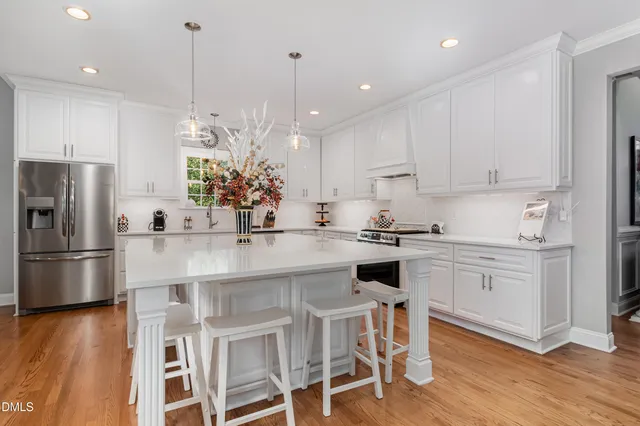 a living room with furniture a flat screen tv and a large window