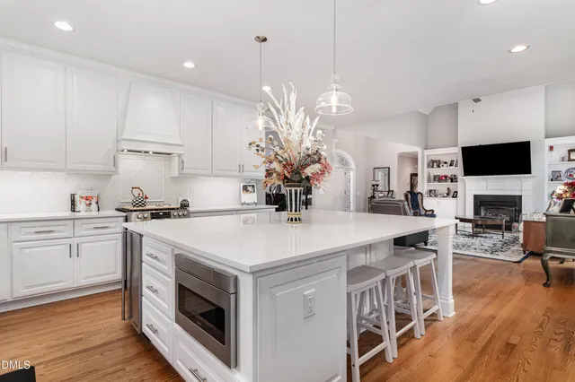 a kitchen with a sink a window and cabinets