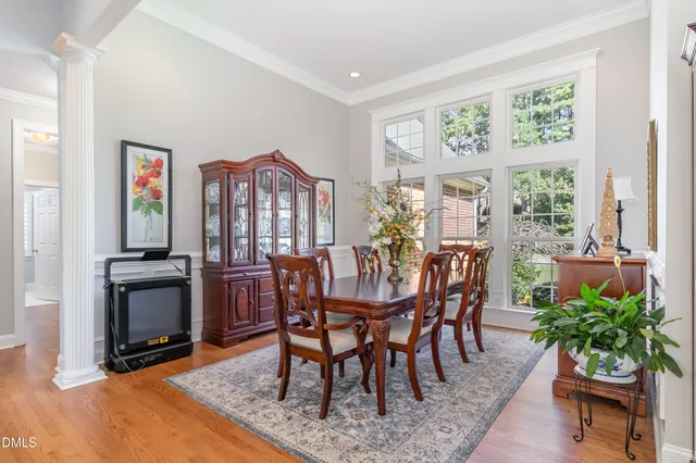 a kitchen that has a lot of white cabinets and wooden floor