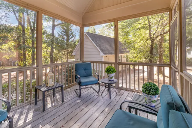 a hallway with furniture and wooden floor