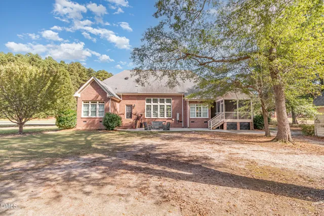 a view of a house with a yard covered in snow