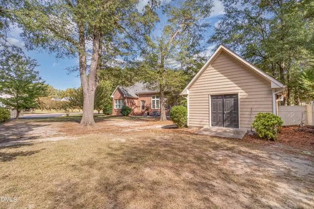 a view of a road with a house in the background