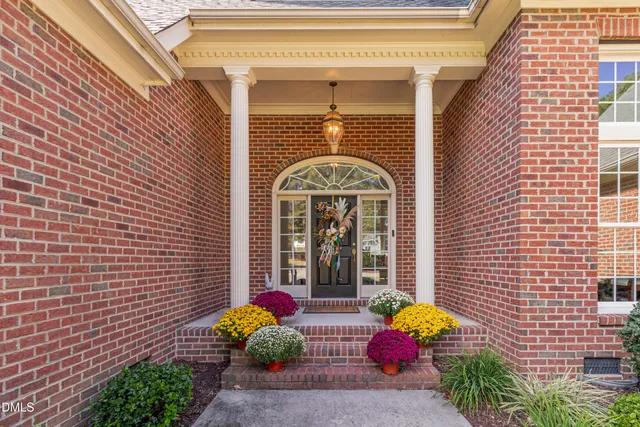 a front view of a house with swimming pool and porch