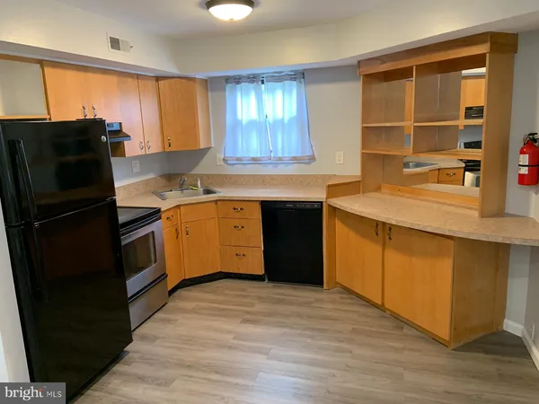 a kitchen with stainless steel appliances granite countertop a stove a sink dishwasher and a refrigerator