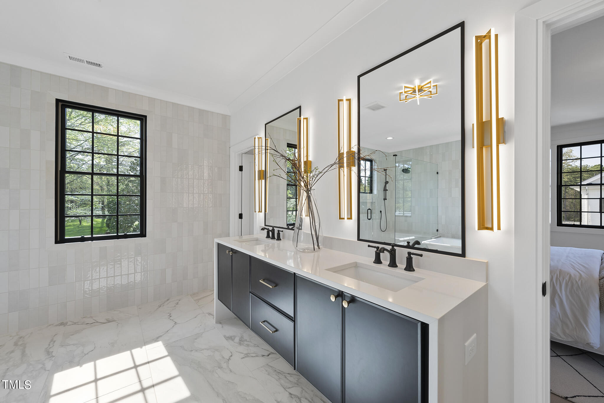 3305 Founding Place Raleigh, NC 27612 - Photo 27 of 100 a bathroom with a double vanity sink a mirror and a bathtub