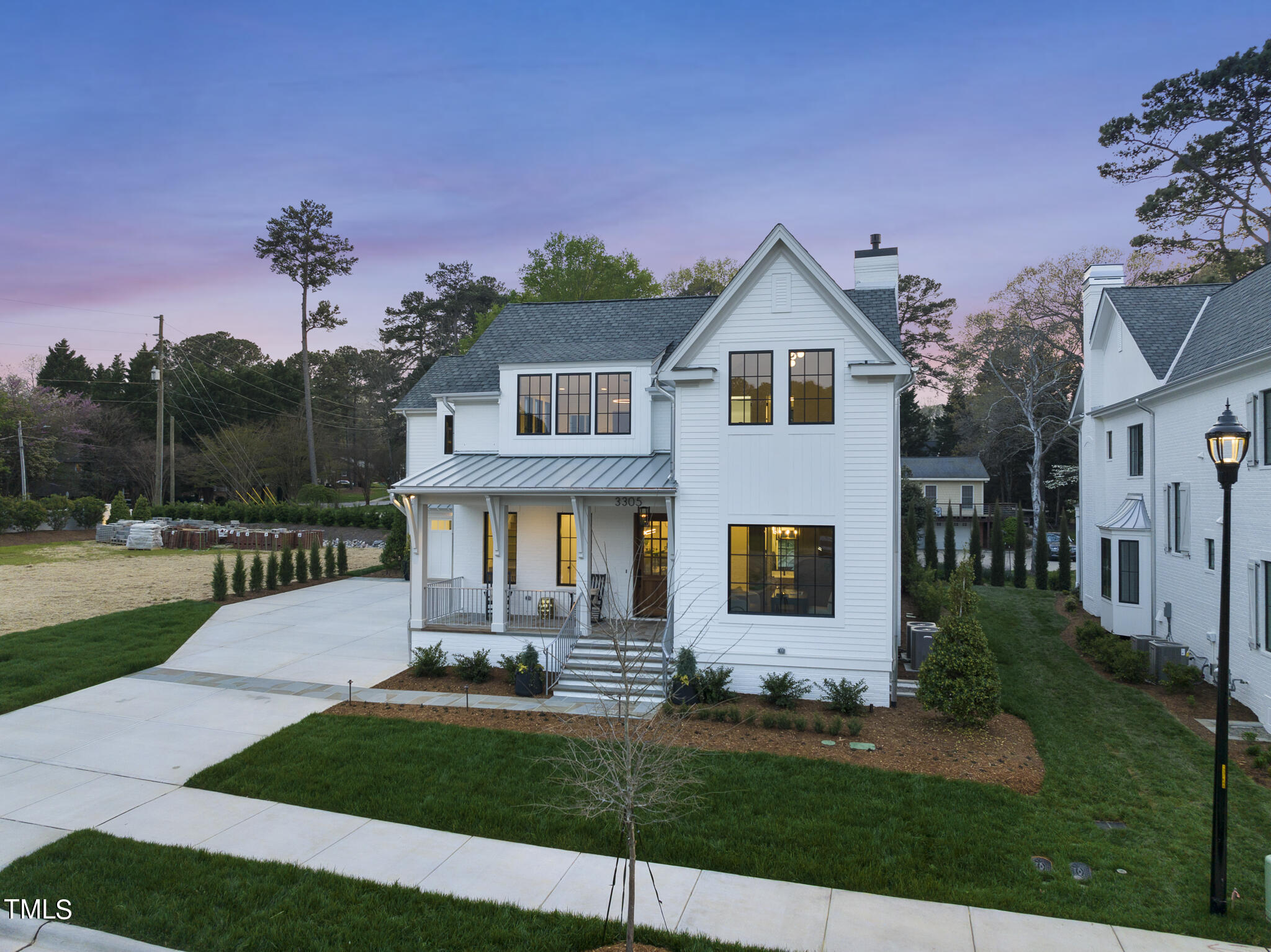 3305 Founding Place Raleigh, NC 27612 - Photo 80 of 100 a front view of a house with a yard and garage
