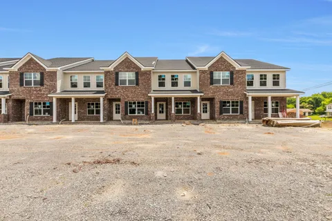 a front view of a residential apartment building with a yard