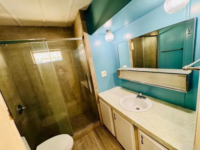 a bathroom with a sink and mirror with bathtub