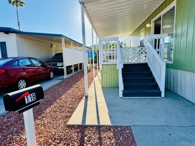a front view of a house with stairs and a floor to ceiling window