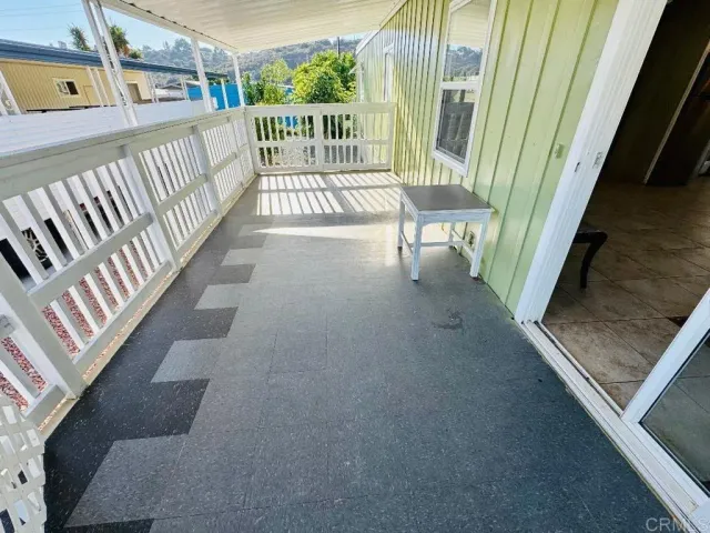 a view of balcony with wooden floor