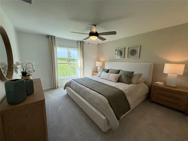 a spacious bedroom with a bed and a couch