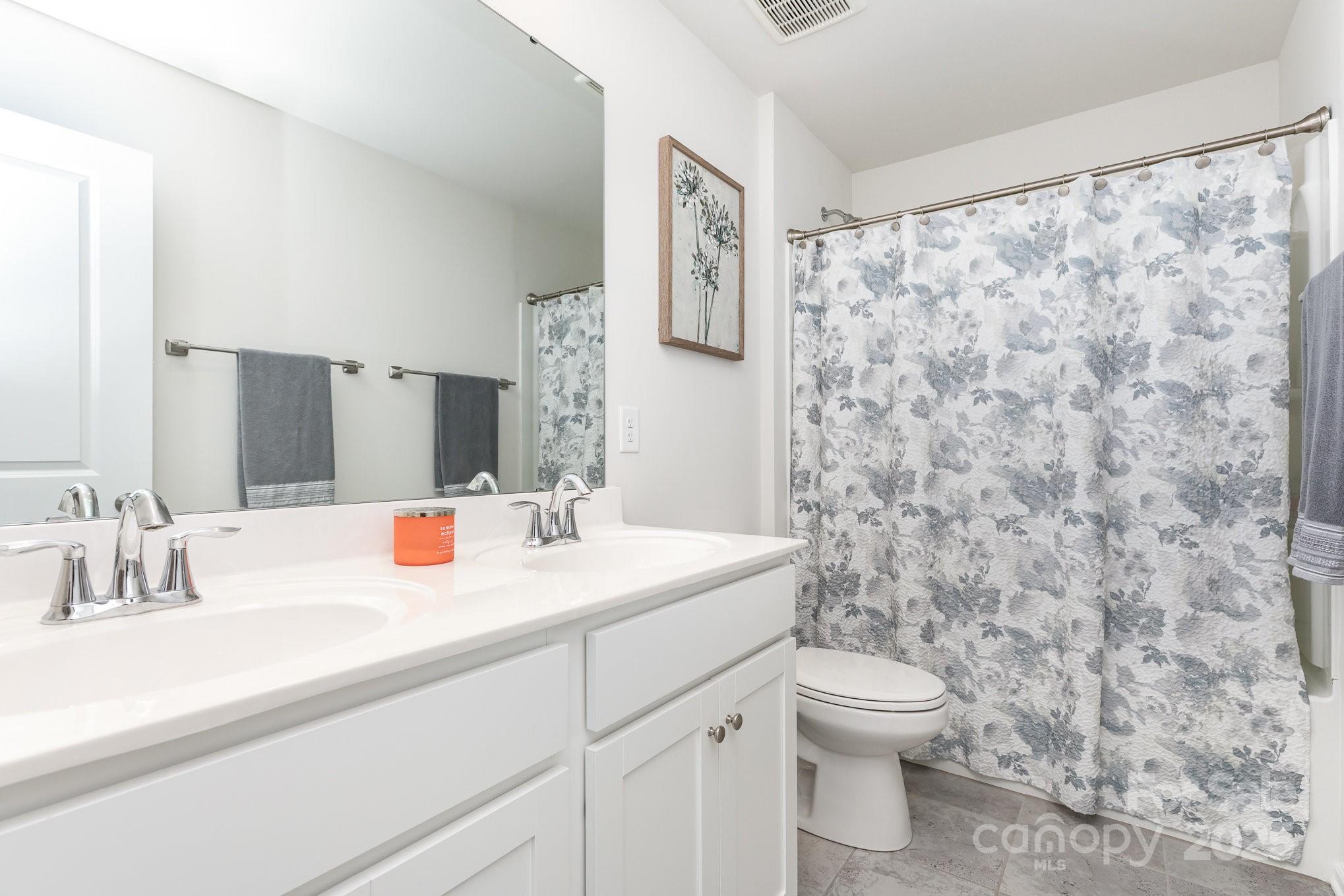1659 Loggerhead Drive Lancaster, SC 29720 - Photo 18 of 29 a bathroom with a granite countertop sink a toilet and a mirror