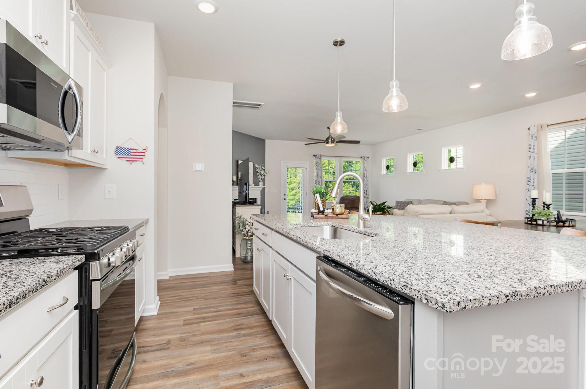 1659 Loggerhead Drive Lancaster, SC 29720 - Photo 2 of 29 a kitchen with stainless steel appliances granite countertop a sink a stove and a wooden floors