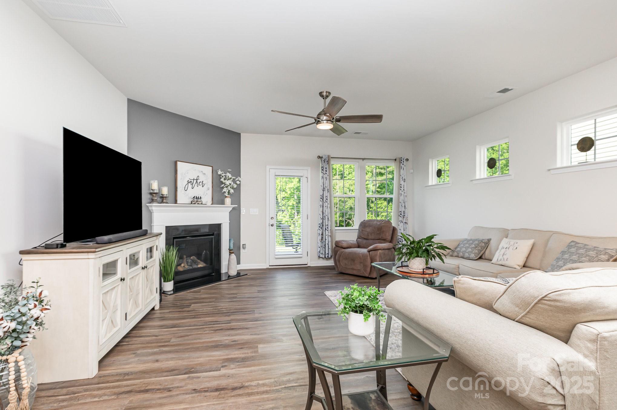 1659 Loggerhead Drive Lancaster, SC 29720 - Photo 4 of 29 a living room with furniture a flat screen tv and a fireplace