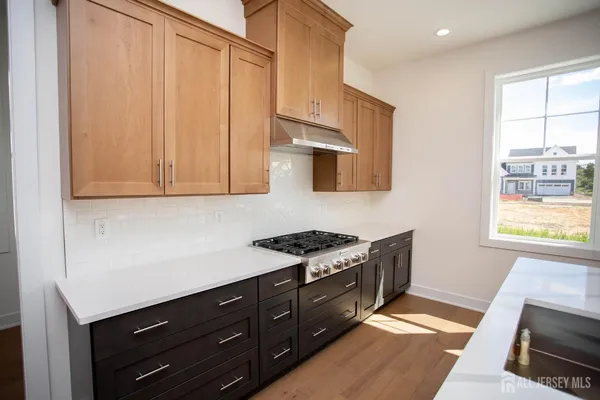 a kitchen with granite countertop a sink a counter top space and living room area