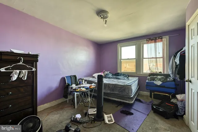 a bedroom with furniture and a flat screen tv