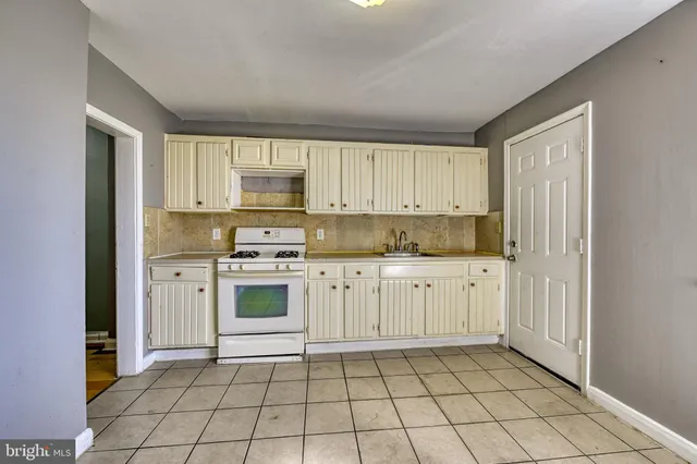 a kitchen with a stove a sink and a refrigerator