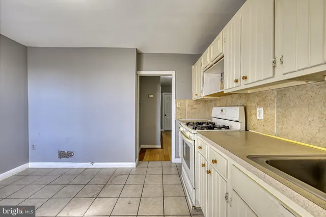 a kitchen with granite countertop a sink and a stove