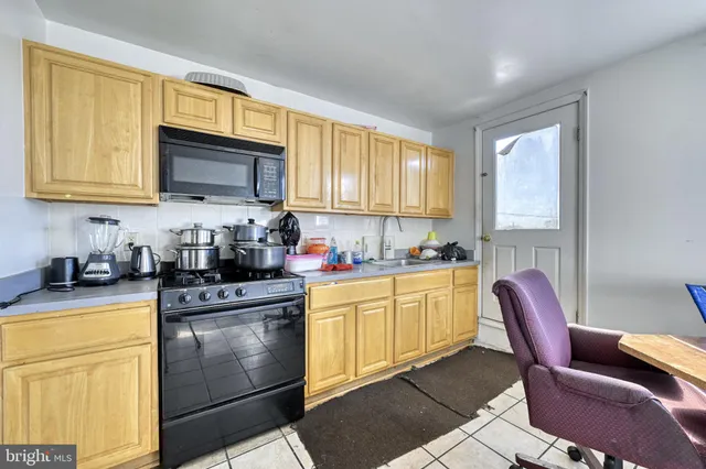 a kitchen with stainless steel appliances granite countertop a stove a sink dishwasher and a microwave oven with granite countertops