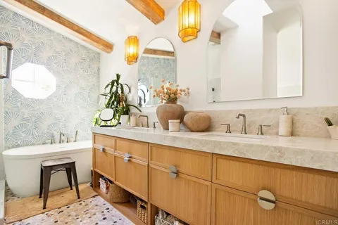 a view of a balcony with wooden floor and fence