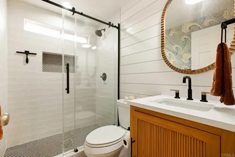 a bedroom with a bed and a painting on the wall