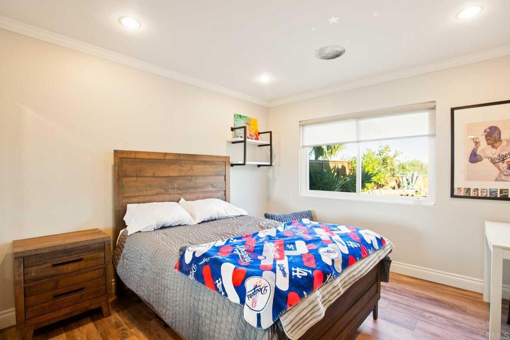 381 Via Almansa Encinitas, CA 92024 - Photo 24 of 32 a bedroom with a bed and a painting on the wall