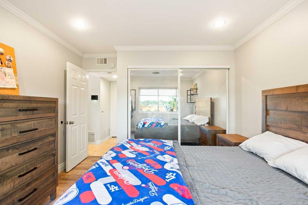 381 Via Almansa Encinitas, CA 92024 - Photo 25 of 32 a bedroom with a bed and wooden floor