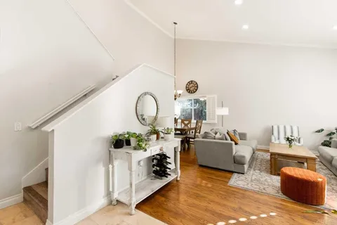 a living room with furniture a rug and white walls