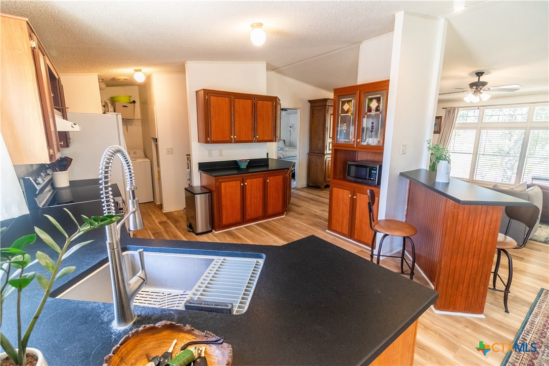 250 Rocky Road Lockhart, TX 78644 - Photo 14 of 45 a living room with furniture a flat screen tv and wooden floor