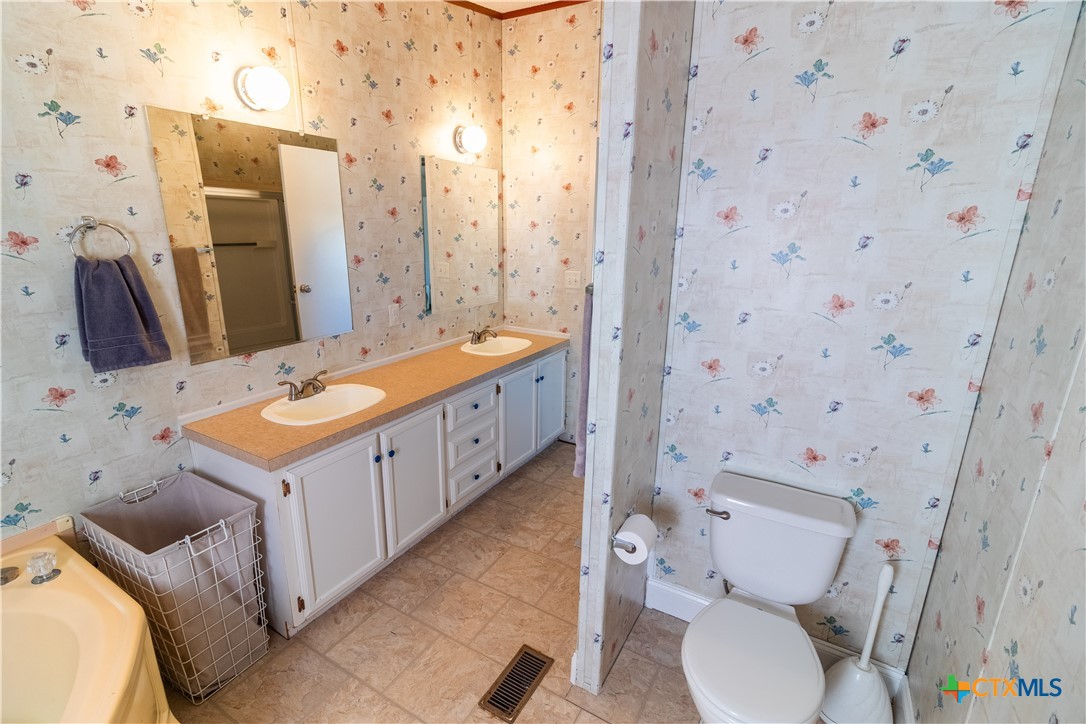 250 Rocky Road Lockhart, TX 78644 - Photo 24 of 45 a bathroom with a sink toilet and shower