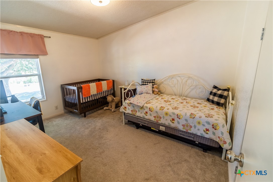 250 Rocky Road Lockhart, TX 78644 - Photo 29 of 45 a bedroom with a bed a flat screen tv and dresser