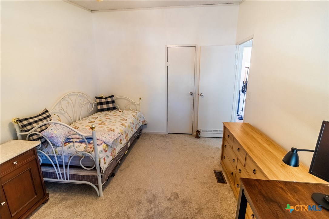 250 Rocky Road Lockhart, TX 78644 - Photo 30 of 45 a bedroom with a bed and a dresser