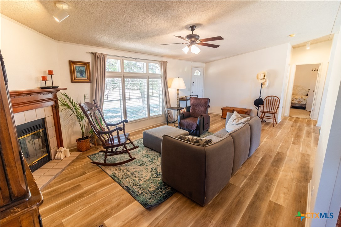 250 Rocky Road Lockhart, TX 78644 - Photo 10 of 45 a living room with furniture a flat screen tv and a floor to ceiling window