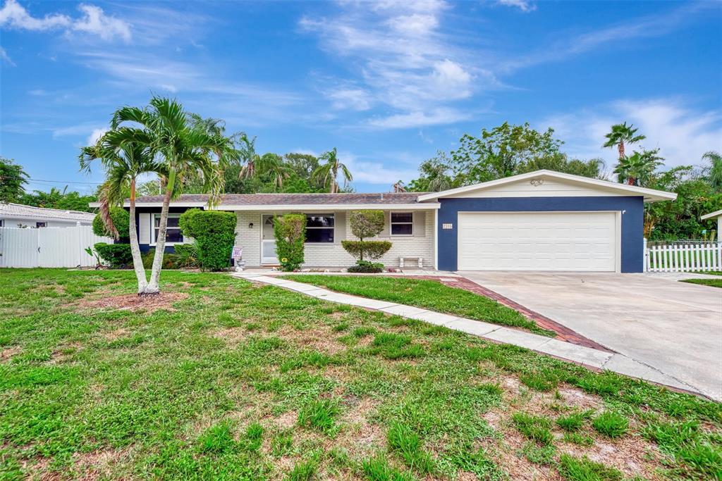 2105 Hyde Park Circle Sarasota, FL 34239 - Photo 1 of 1 a front view of a house with a yard and a garage