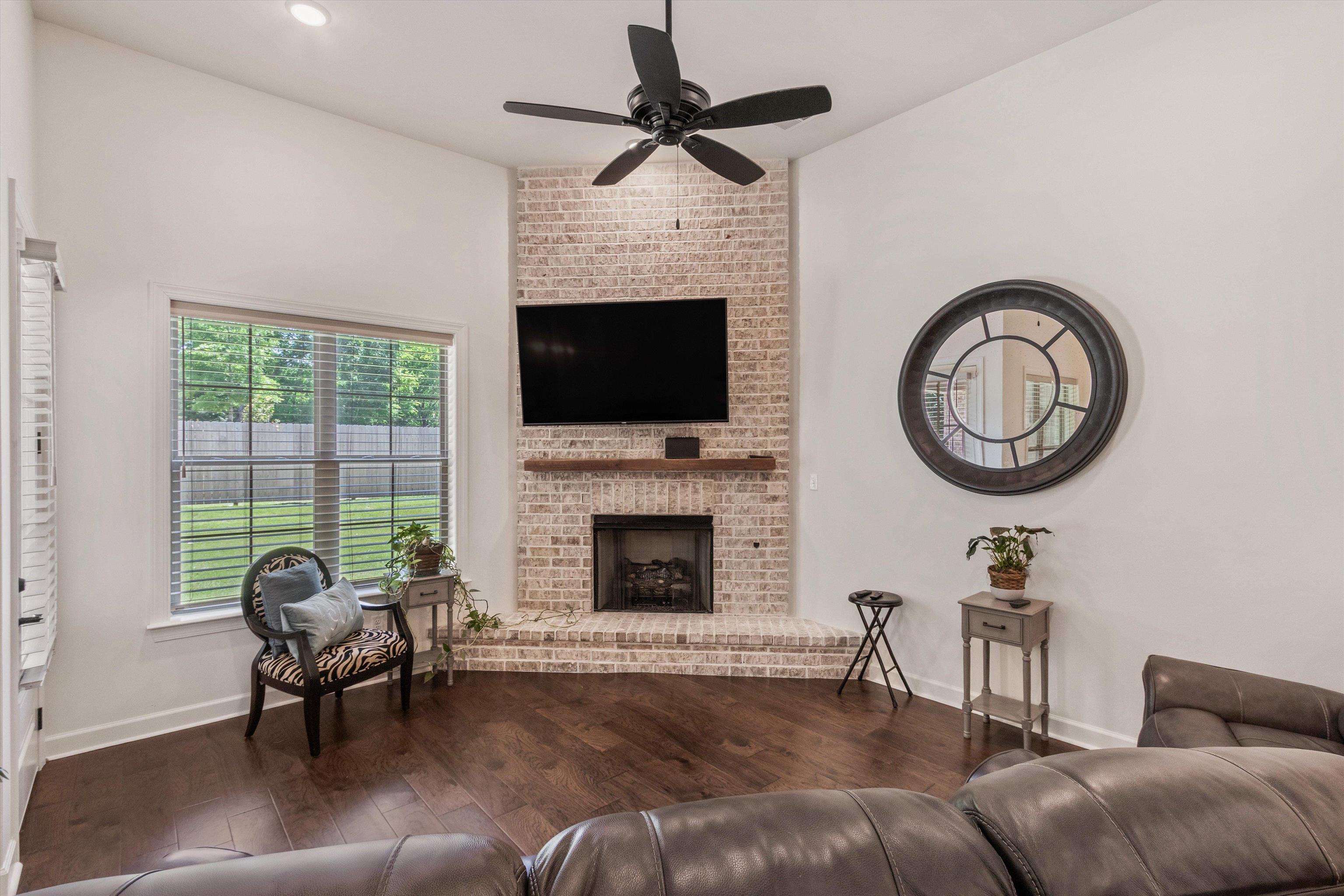 65 Watson Road Oakland, TN 38060 - Photo 13 of 40 a living room with furniture a fireplace and a flat screen tv