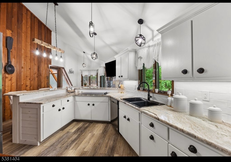 56 Sleepy Hollow Road Andover, NJ 07821 - Photo 11 of 37 a large kitchen with granite countertop a white sink and cabinets