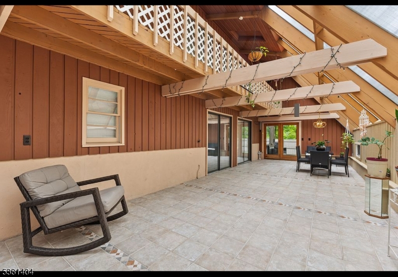 56 Sleepy Hollow Road Andover, NJ 07821 - Photo 14 of 37 a view of a chairs and table in patio of a house