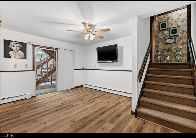 56 Sleepy Hollow Road Andover, NJ 07821 - Photo 18 of 37 a view of an empty room with wooden floor and workspace