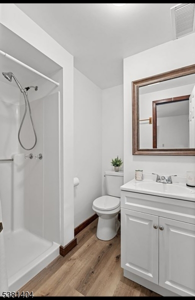 56 Sleepy Hollow Road Andover, NJ 07821 - Photo 20 of 37 a bathroom with a toilet sink and mirror